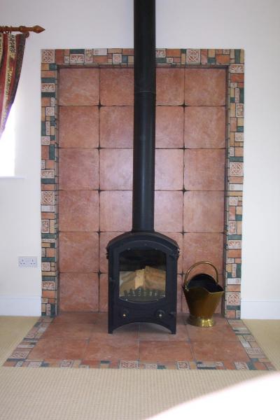 Fireplace tiled with porcelain tiles.