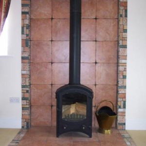 Fireplace tiled with porcelain tiles.
