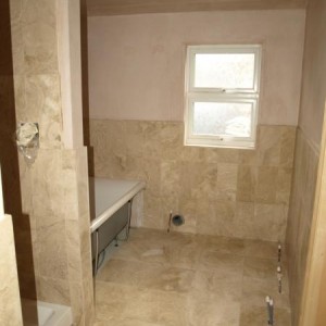 Honed filled travertine bathroom walls and floor.
