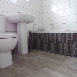 White tiles with feature decors and grey grout