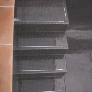 black glass mosaic steps with stainless steel inlay