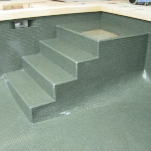 grey glass mosaic steps in pool