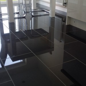 2 polished Porcelain Floors and a black metro Splashback