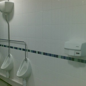 Mens Toilets urinals were to cut around