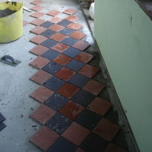 Cloister 8 - And off we go. Oh damn. the black tiles are smaller than the red ones so do away with the spacers......