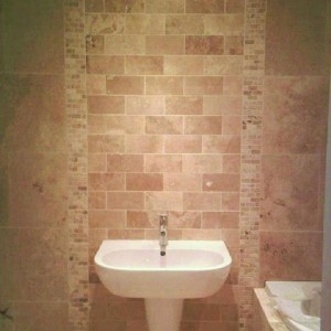 Travertine - Honed and filled with tumbled travertine mosaic vertical decor lines. Center panel hand cut from 600x400 main tile. Curved Bath panel in 20mm strips from main tile.