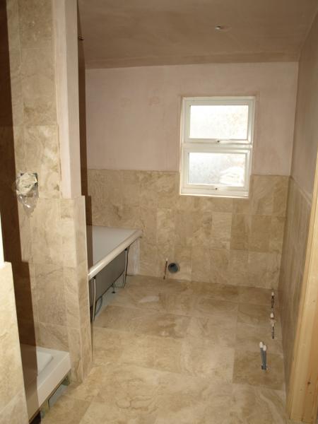 Honed filled travertine bathroom walls and floor.