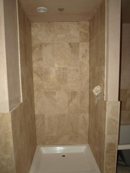 Honed filled travertine shower walls.